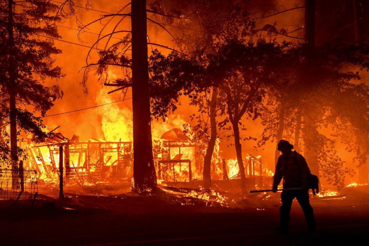 California’s largest fire burns homes as blazes scorch US West